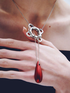 Swim Tube Necklace in Red worn around neck, close-up view |Color:Red