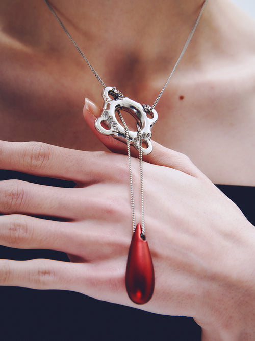 Swim Tube Necklace in Red worn around neck, close-up view |Color:Red