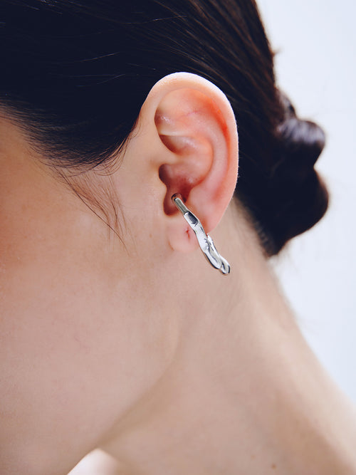 Drip Ear Cuff in Silver worn on ear, close-up view |Color:Silver