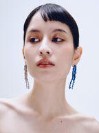 Drop Stand Earring in Silver and Blue worn on both ears, front view