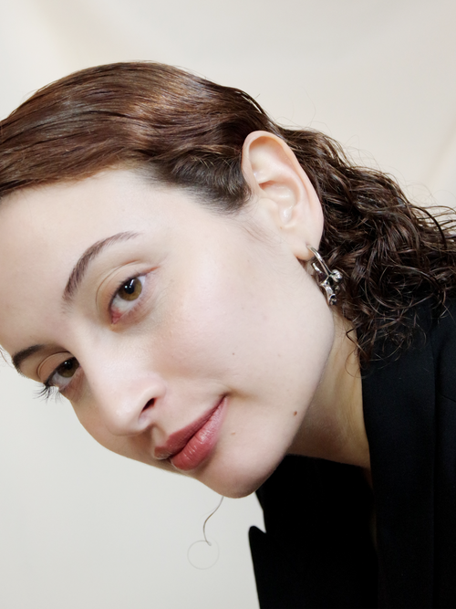 Flux Earring in Silver worn on ear, tilted portrait view |Color:Silver