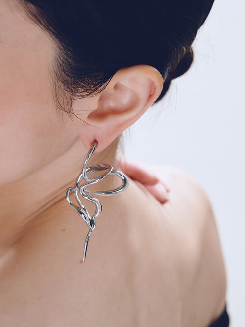 PermaDaze Earring in Silver worn on ear, close-up view |Color:Silver