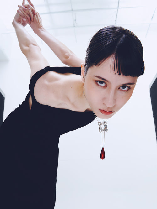 Swim Tube Necklace in Red worn around neck, full-body view |Color:Red