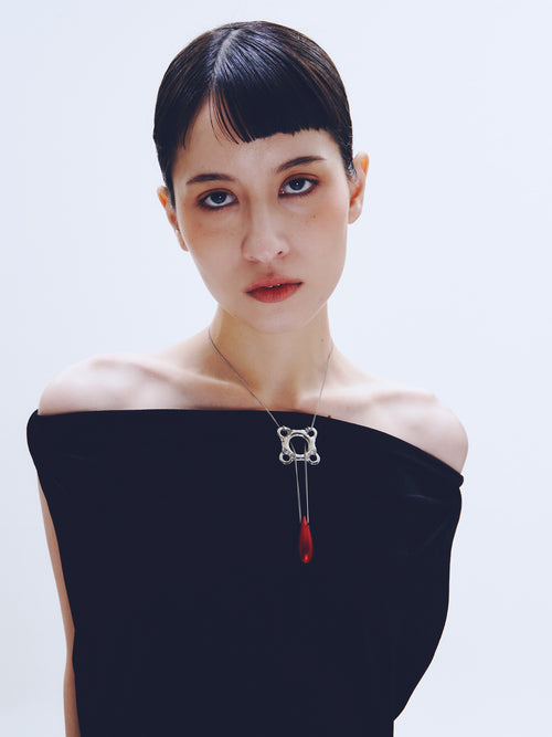 necklace_red_worn_04
Swim Tube Necklace in Red worn around neck, front view |Color:Red