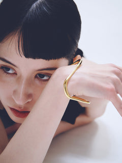 Wave Bracelet in Gold worn on wrist, close-up view |Color:Gold